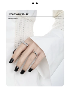 Detail showing S925 sterling silver stacked rings with zircons on model with black nails