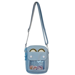 Detail of light blue crossbody ita bag with clear PVC window and adjustable strap