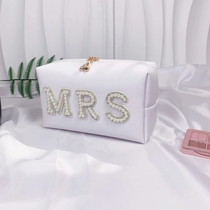 White textured fabric Mrs makeup bag with pearl lettering on soft white silk fabric