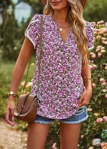 Close-up of elegant V-neck floral T-shirt with white lace trim on sleeves