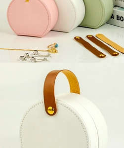 Detail of portable leather jewelry boxes with snap closure and handles in various colors