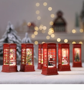 Macro shot of red Christmas telephone booth lights with Santa and snowman scenes