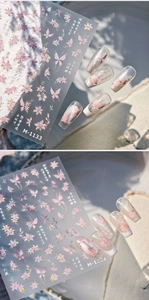 Macro shot of M-1133 nail art stickers featuring pink holographic butterfly and lily patterns