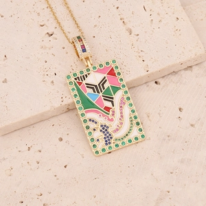 Detail of 18K gold tarot card necklace with colorful enamel inlay and zircon stones
