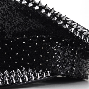 Detailed macro view of black sequin hat with silver punk spikes and sparkling rhinestones