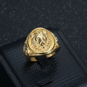 Hip hop lion head gold ring for men with intricate engraving on a black jewelry stand