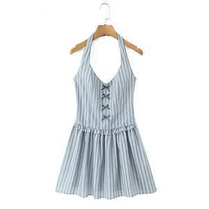 Detail of blue and white striped halter dress with bow accents and ruffled hem on hanger