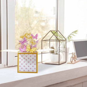 Detailed 3D pop-up greeting card featuring pink and gold butterflies in a yellow gift box