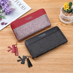 Detailed close-up of long zip wallets with color stitching and glitter sequin finish
