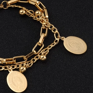 Detail shot of dual-layer 18k gold chain with Virgin Mary Guadalupe relief charms
