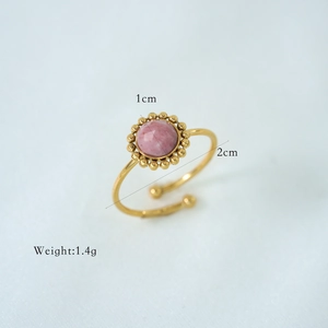 Macro detail of a 1cm pink gemstone ring with golden adjustable band and weight specifications