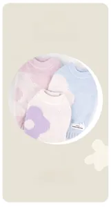 Detail view of cozy knitted pet sweaters with floral patterns and a decorative fabric tag