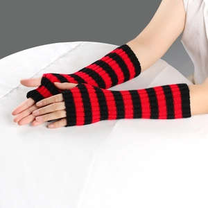 Close-up of red and black striped knitted fingerless gloves for autumn and winter warmth