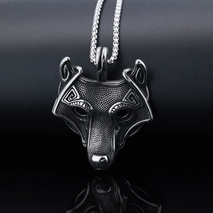 Macro view of vintage stainless steel wolf head pendant with intricate engraved metal texture