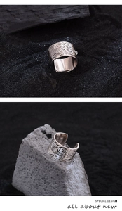 Detailed view of vintage silver wide band ring featuring intricate floral scroll engravings