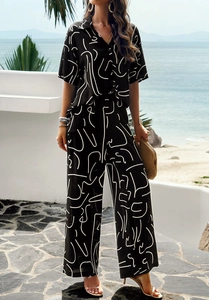 Abstract face print short sleeve shirt and wide leg pants set styled at the seaside