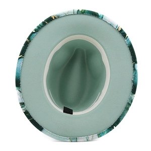 Detailed view of wide brim fedora hat interior with mint lining and marble print brim