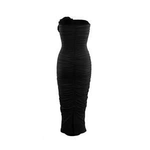 Detailed back view of black strapless ruched dress with hem slit and elastic fabric
