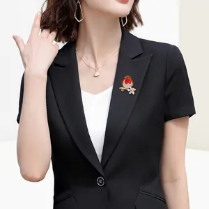 Exquisite red robin bird brooch with rhinestones worn on a professional black blazer suit