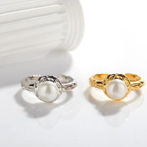 Detailed macro shot of S925 silver pearl rings with molten texture and adjustable band