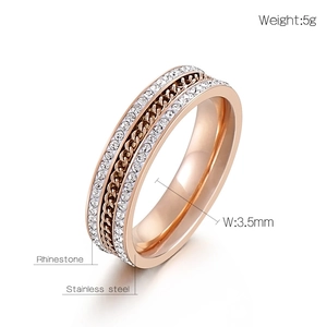 Macro detail of rose gold stainless steel ring with double-row rhinestones and chain design