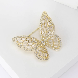 Exquisite gold butterfly brooch with cubic zirconia crystals on a clean white stand