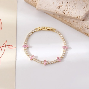 Detailaufnahme von Goldarmband mit Zirkonia, rosa Markisesteinen und Faltschließe