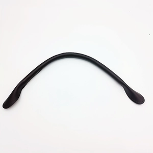 Detail of a thick black leather handbag strap featuring durable stitching and pre-drilled holes