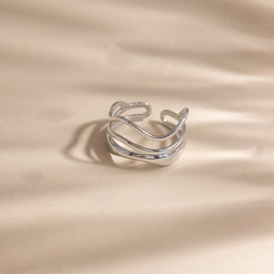 Detail of layered silver wave ring with polished finish and open adjustable design