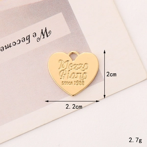 Macro shot of gold heart-shaped metal charm with Mezzo Piano since 1988 engraving