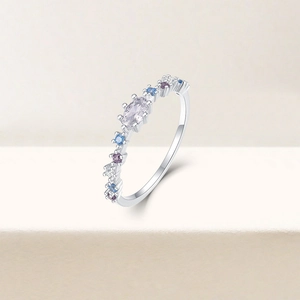 Macro shot of silver ring with colorful zircons and large oval crystal centerpiece