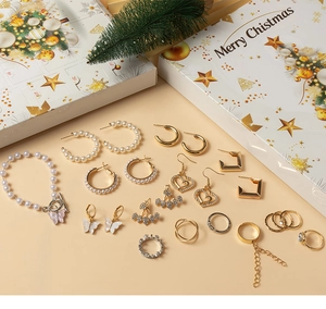 Christmas jewelry advent calendar set with pearl earrings and festive gift boxes
