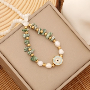 Bohemian natural green stone and pearl necklace with a blue evil eye pendant