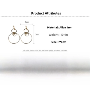 Macro detail of geometric hollow round drop earrings with dimensions and gold finish