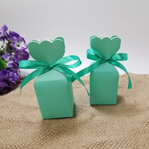 Detail of mint green candy gift box with elegant wavy petal top and ribbon bow tie
