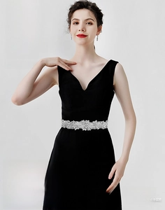 Detail of luxury rhinestone floral bridal belt on a black V-neck sleeveless gown