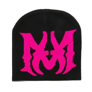Detail of black knit beanie featuring neon pink gothic jacquard pattern for winter