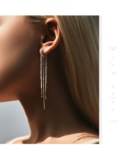 Macro shot of long silver tassel earrings on model showing delicate chain details