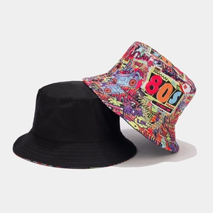 Detail view of reversible 80s retro graffiti print and solid black cotton bucket hats