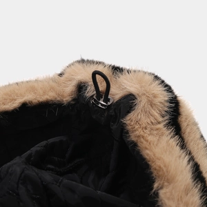 Detail of black quilted fabric with faux fur trim and adjustable elastic drawstring cord