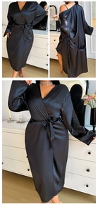 Detail of elegant black satin long robe with a silk waist tie in a modern home setting
