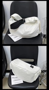 Detail of white nylon fitness bag with adjustable wide black strap and glossy finish