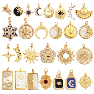 Golden celestial charm set featuring sun, moon and star designs with crystal inlay