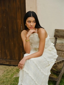 Elegant white halter neck pleated maxi dress for women on a summer beach vacation