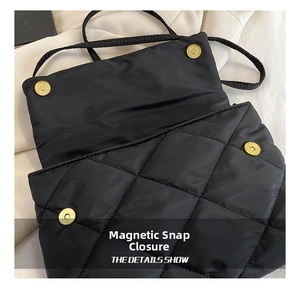 Close-up of quilted black nylon shoulder bag featuring a secure golden magnetic buckle