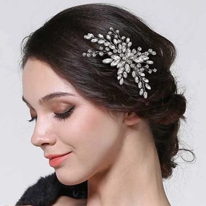 Silver bridal hair comb with crystal rhinestones worn on hair by a fashion model