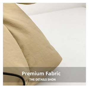 Detailed close-up of khaki padded nylon fabric with black drawstring on a quilted tote bag