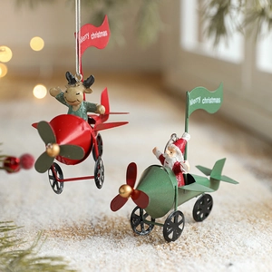 Christmas airplane hanging ornaments with Santa and reindeer on snowy festive background