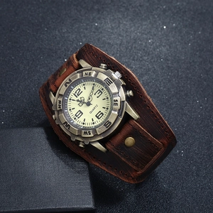 Macro shot of vintage brown leather strap and bronze metal casing on a punk style watch