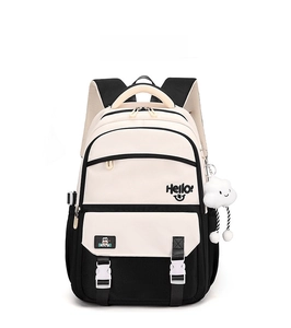 Close-up of black and white student backpack with Hello smile print and cloud plush charm